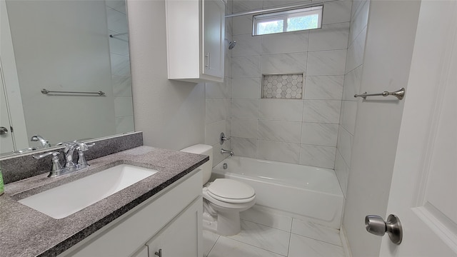 full bathroom featuring tiled shower / bath combo, vanity, and toilet