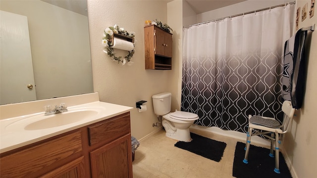 bathroom with tile patterned flooring, vanity, and toilet