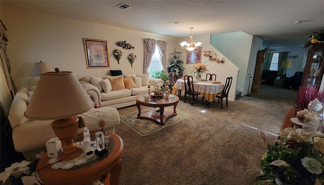 living room with a textured ceiling, ceiling fan with notable chandelier, and carpet flooring