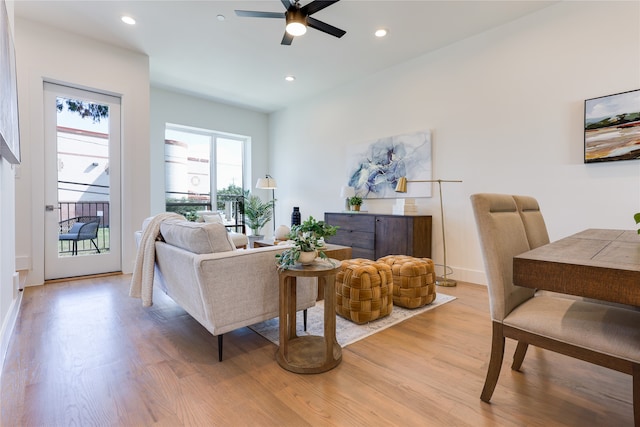 living room with ceiling fan and light wood-type flooring