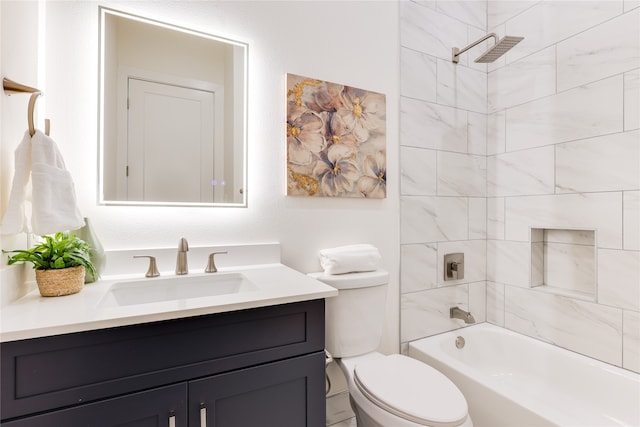 full bathroom featuring tiled shower / bath, vanity, and toilet