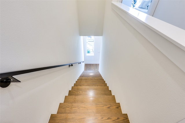 stairs featuring hardwood / wood-style floors