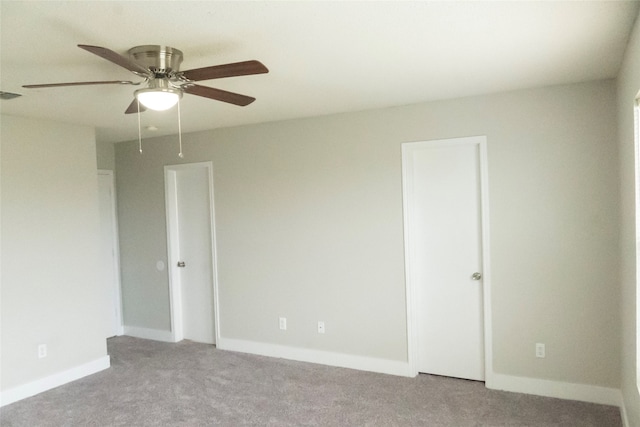 unfurnished room featuring ceiling fan and light colored carpet