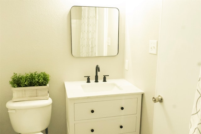 bathroom featuring vanity and toilet