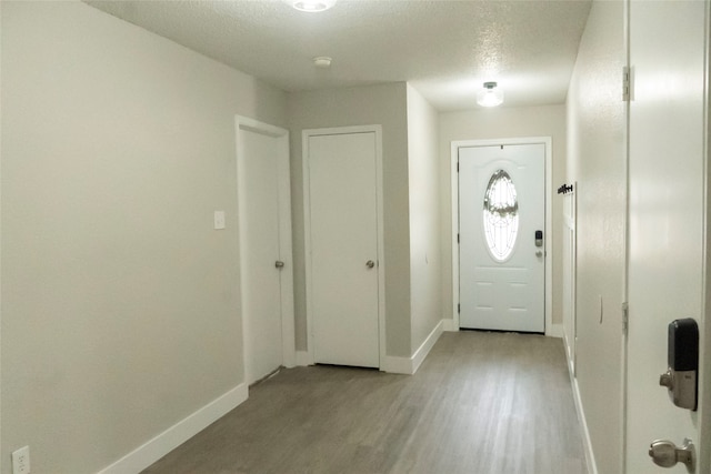 entrance foyer featuring a textured ceiling and light hardwood / wood-style flooring