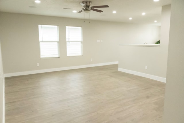 spare room with light hardwood / wood-style floors and ceiling fan