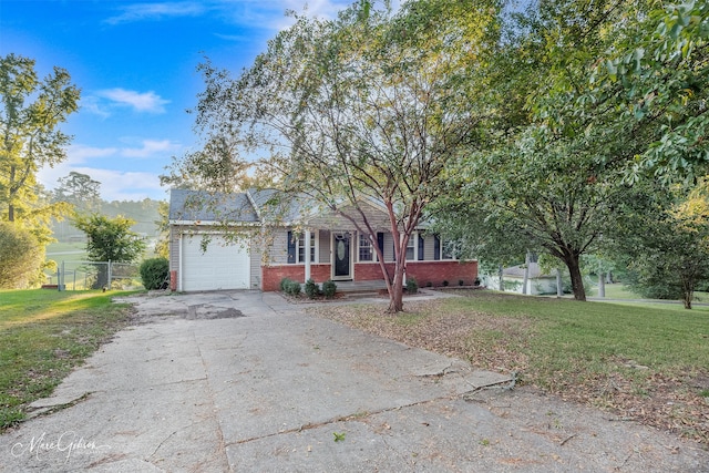 view of front of home with a front yard and a garage