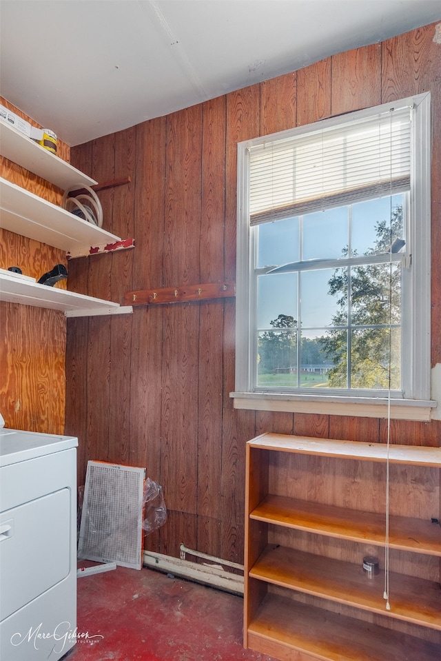 washroom featuring wooden walls and washer / dryer