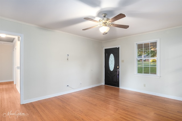 foyer with crown molding, light hardwood / wood-style floors, and ceiling fan