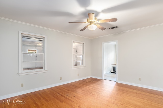 empty room featuring ceiling fan, crown molding, and light hardwood / wood-style floors