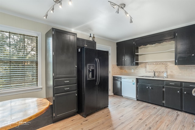 kitchen featuring white dishwasher, sink, black refrigerator with ice dispenser, crown molding, and light hardwood / wood-style floors