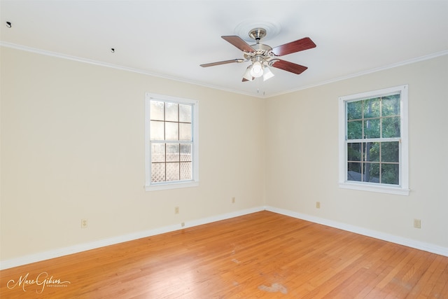 empty room featuring ornamental molding, light hardwood / wood-style floors, and ceiling fan