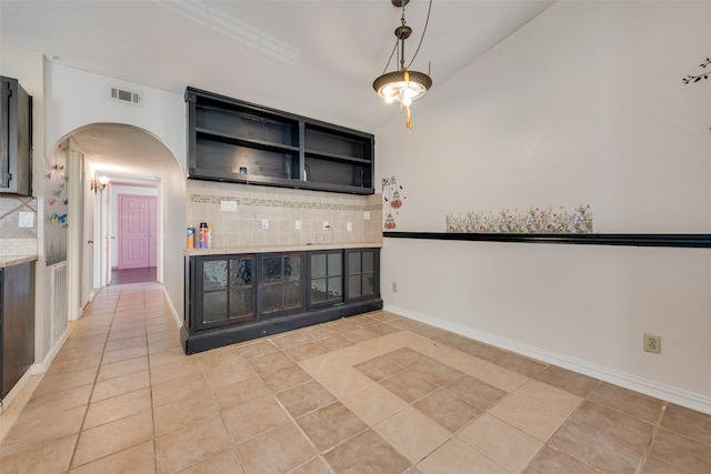 kitchen featuring decorative backsplash and light tile patterned flooring