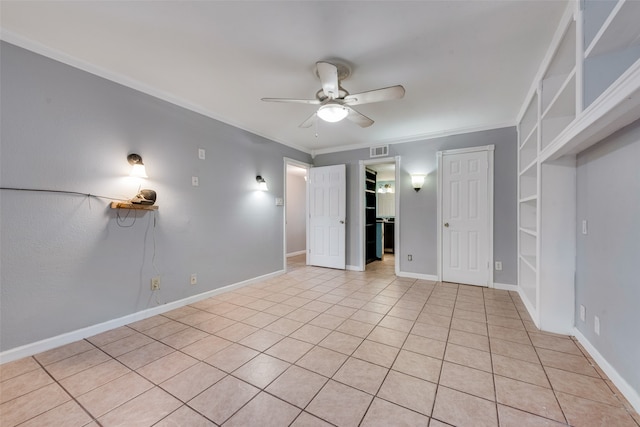 empty room with ceiling fan, light tile patterned floors, and ornamental molding