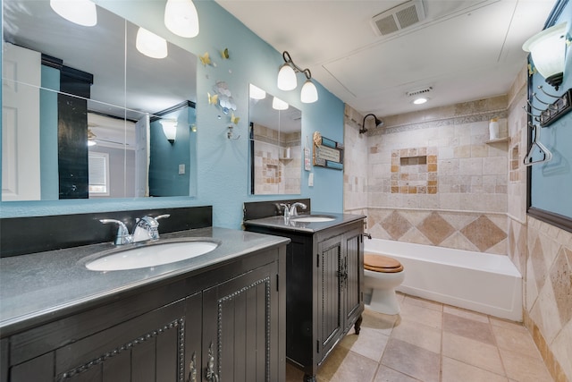 full bathroom with vanity, tiled shower / bath combo, tile walls, tile patterned flooring, and toilet