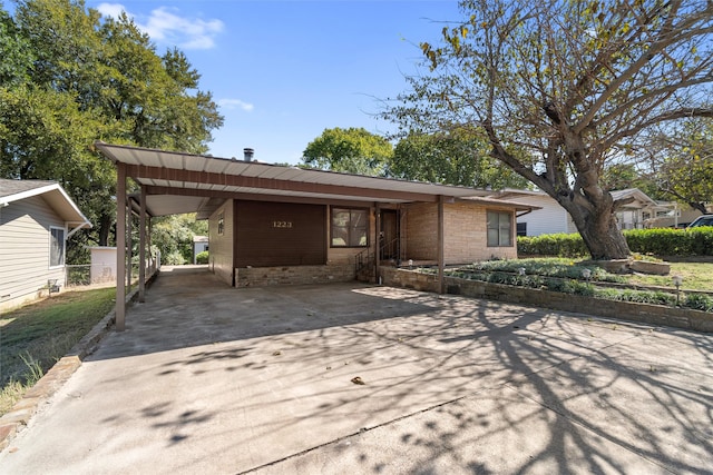 ranch-style home featuring a carport