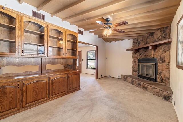 unfurnished living room with beam ceiling, ceiling fan, and light carpet