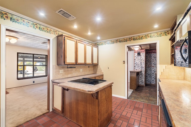 kitchen featuring ornamental molding, kitchen peninsula, dark colored carpet, black electric stovetop, and a breakfast bar area