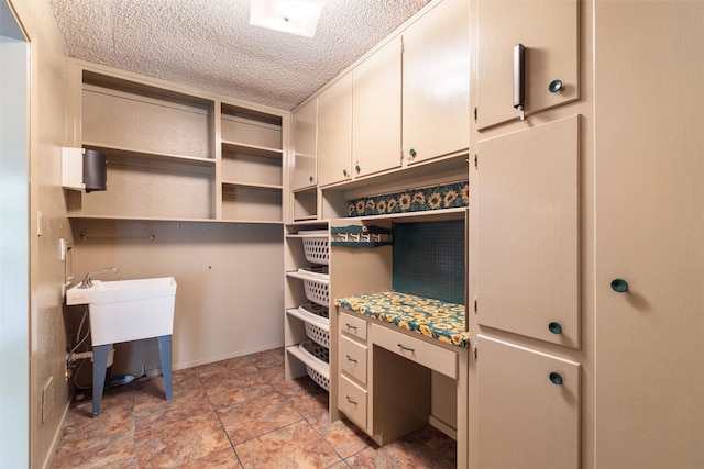 interior space featuring a textured ceiling and sink