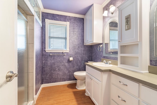 bathroom with toilet, hardwood / wood-style floors, and a healthy amount of sunlight