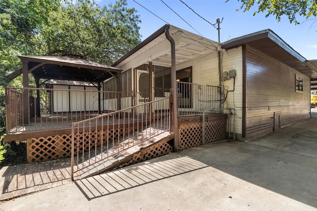 rear view of property featuring a deck