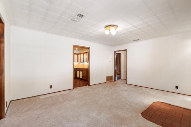 carpeted spare room featuring ornamental molding