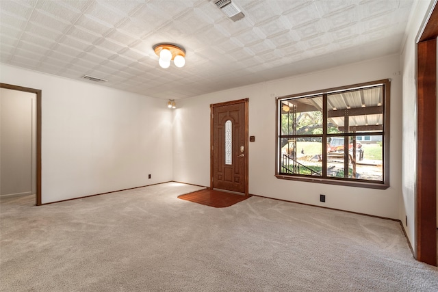 foyer entrance featuring light colored carpet