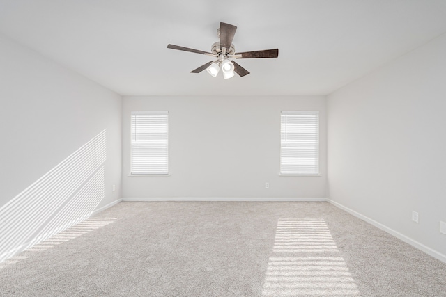 spare room with ceiling fan and light colored carpet