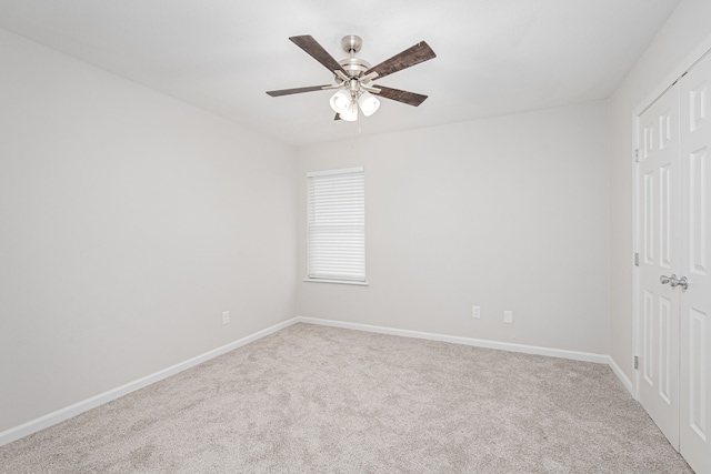 carpeted empty room featuring ceiling fan