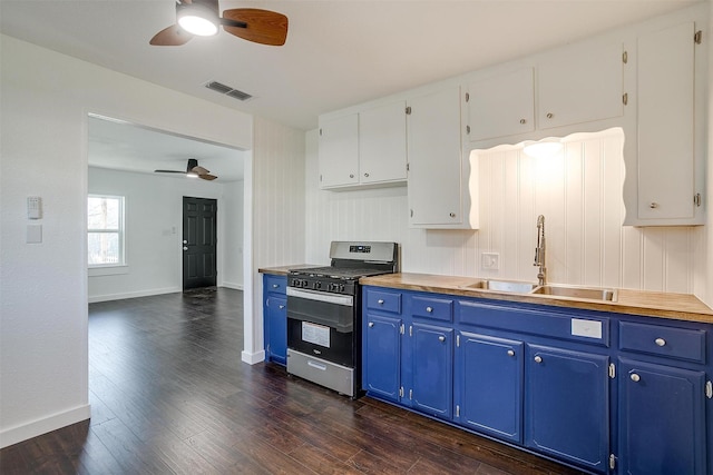 kitchen featuring gas stove, blue cabinets, sink, white cabinets, and dark hardwood / wood-style floors