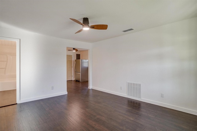 empty room with ceiling fan and dark hardwood / wood-style floors