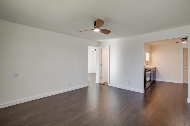 unfurnished living room featuring ceiling fan and dark hardwood / wood-style flooring