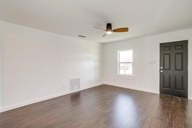 spare room featuring ceiling fan and dark wood-type flooring