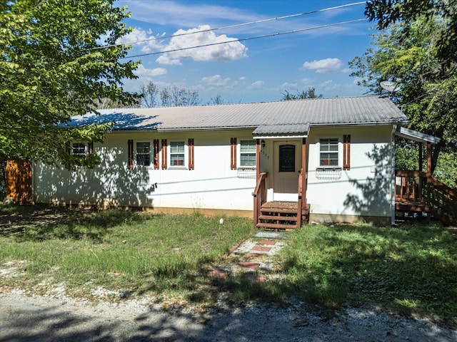 ranch-style house with entry steps and metal roof