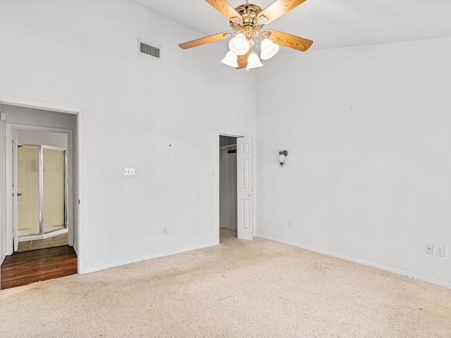 carpeted spare room with ceiling fan