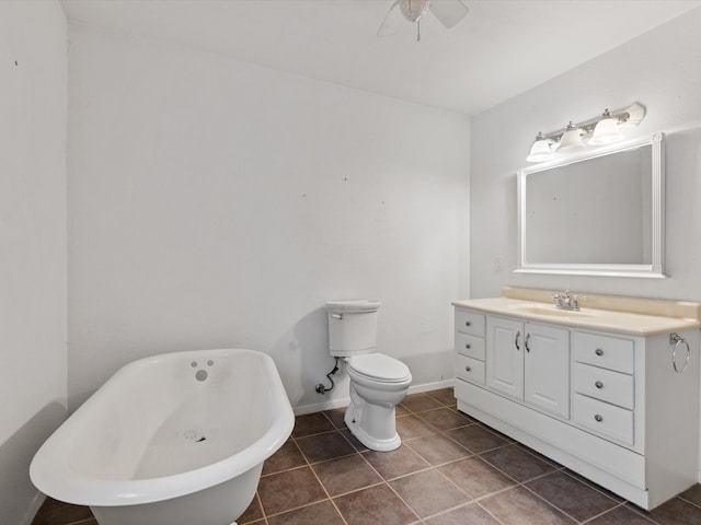 bathroom featuring tile patterned floors, a washtub, vanity, ceiling fan, and toilet