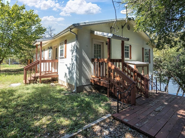 back of property with a wooden deck