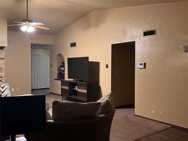 living room featuring lofted ceiling, wood-type flooring, and ceiling fan