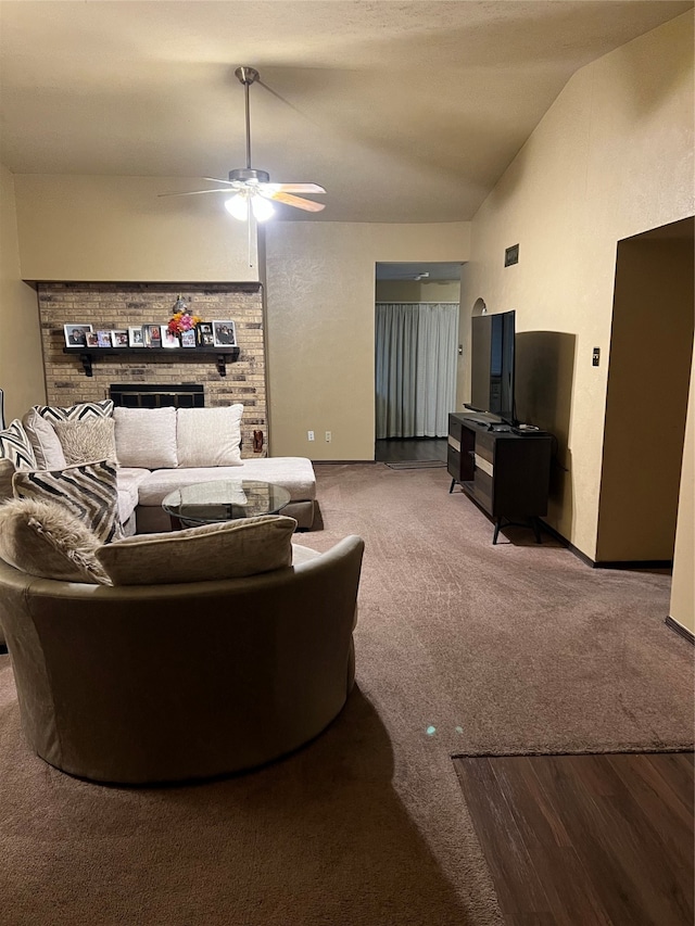 carpeted living room with lofted ceiling, a fireplace, and ceiling fan