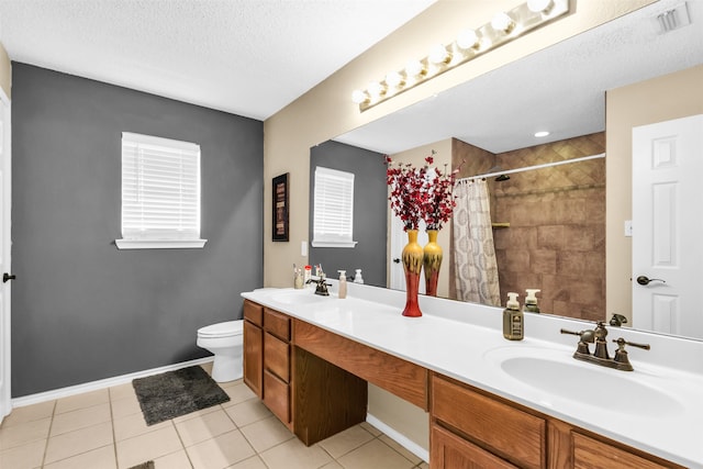 bathroom featuring vanity, toilet, a textured ceiling, walk in shower, and tile patterned flooring