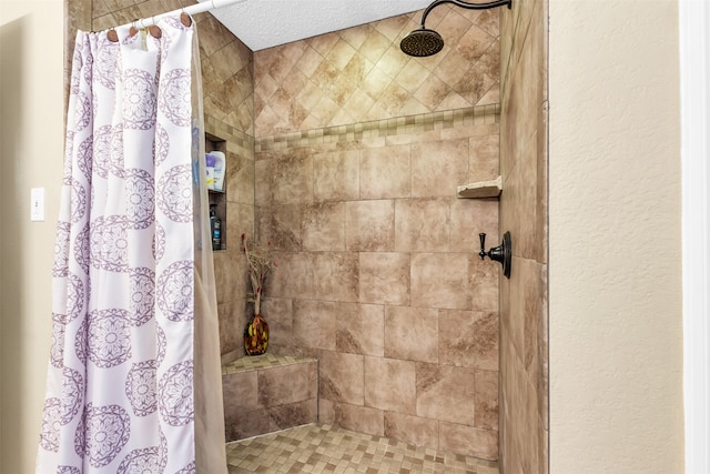 bathroom featuring walk in shower and a textured ceiling