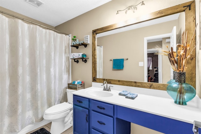 bathroom featuring vanity, a textured ceiling, tile patterned flooring, a shower with shower curtain, and toilet