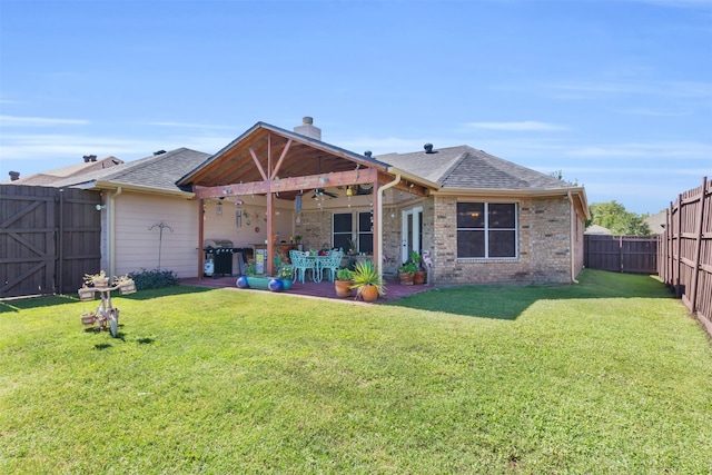 back of house with ceiling fan, a yard, and a patio