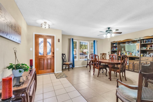 tiled entrance foyer featuring ceiling fan and a textured ceiling