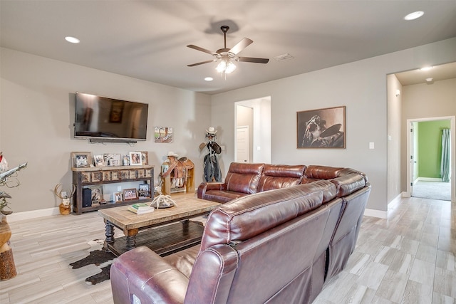 living room with light hardwood / wood-style floors and ceiling fan