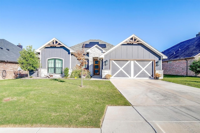 craftsman-style house with a garage and a front lawn