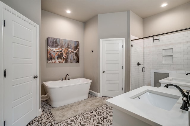 bathroom with plus walk in shower, tile patterned floors, and vanity