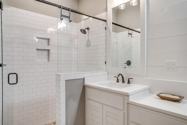 bathroom featuring walk in shower and vanity