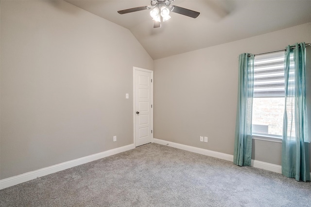 carpeted spare room with lofted ceiling and ceiling fan