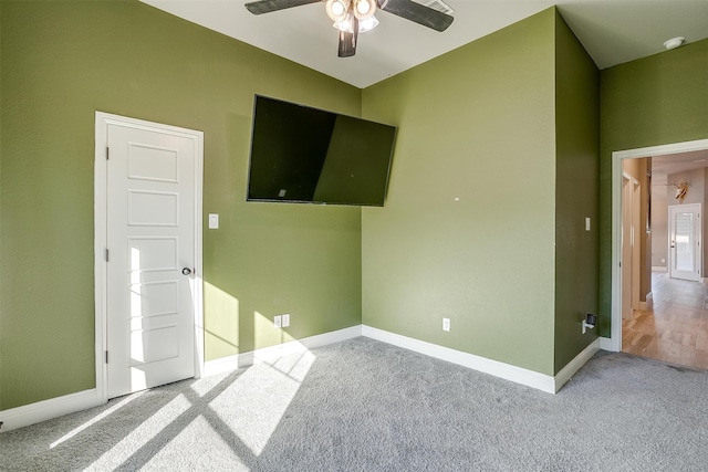 unfurnished bedroom featuring ceiling fan and light carpet